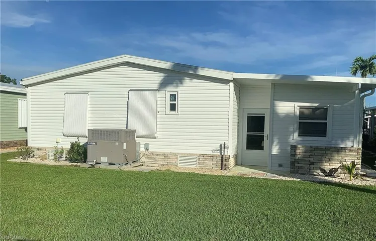 Manicured open lawn area in back yard