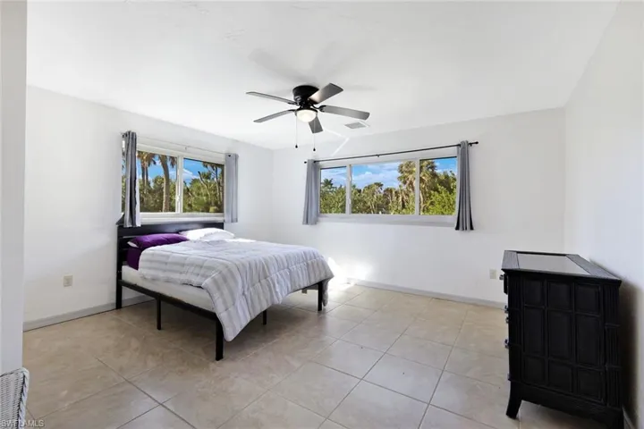 Bedroom with a ceiling fan and light tile patterned floors