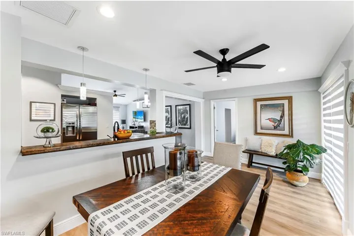 Dining space with ceiling fan, wood finished floors, recessed lighting, and baseboards