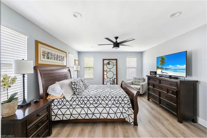 Bedroom featuring light wood finished floors, a ceiling fan, and recessed lighting