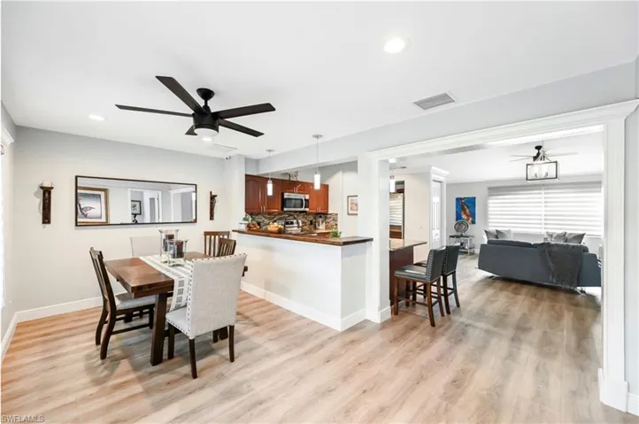 Dining area featuring ceiling fan, light wood-type flooring, recessed lighting, and baseboards