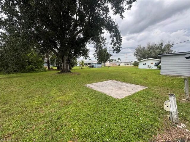 View of green lawn featuring a patio area