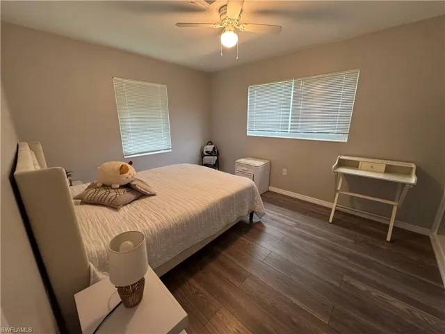 Bedroom featuring dark wood-type flooring and ceiling fan