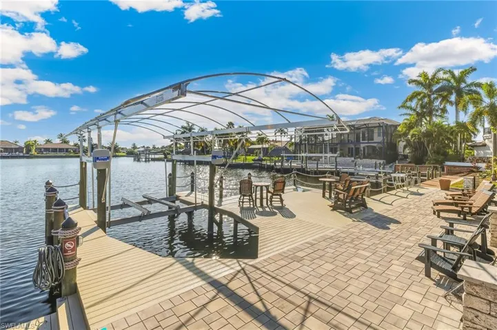 Dock area featuring boat lift and a water view