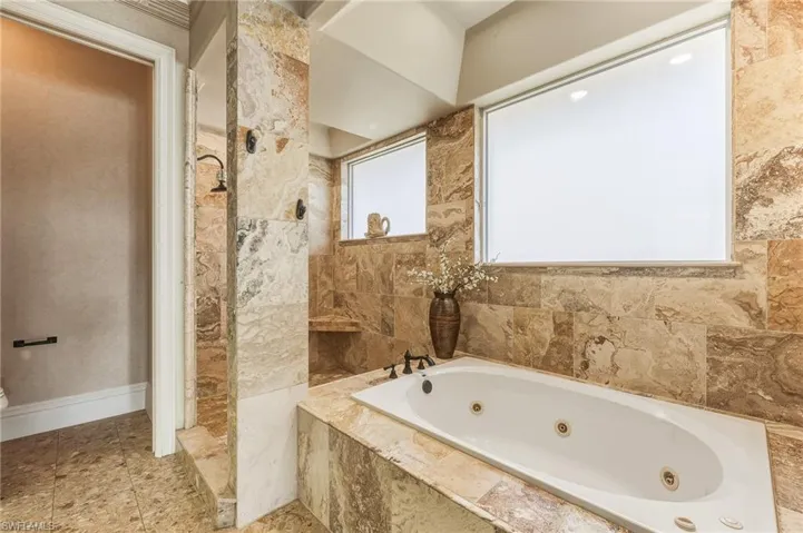 Bathroom with a whirlpool tub and walk in shower