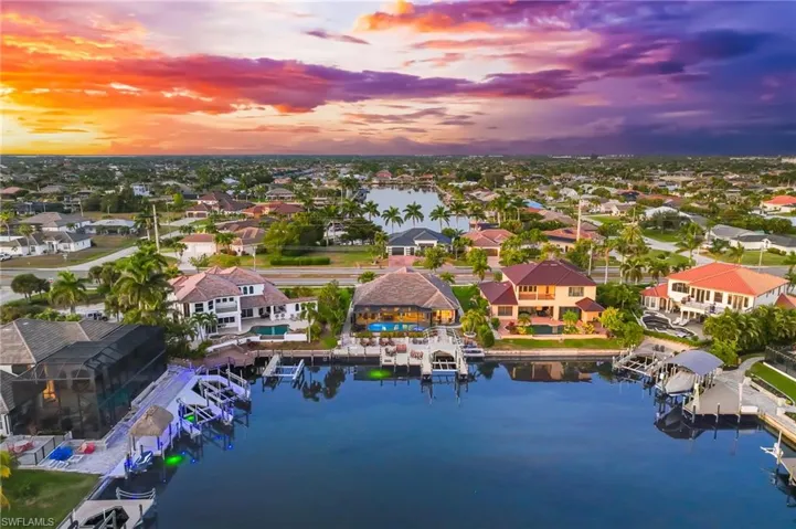 Aerial view at dusk of a water view and a residential view