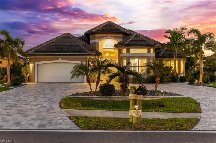 Mediterranean / spanish-style home featuring decorative driveway, stucco siding, an attached garage, and a tile roof