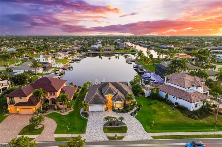 Aerial view at dusk of a water view and a residential view