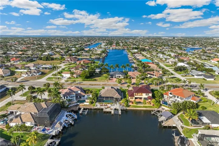 Aerial perspective of suburban area featuring a nearby body of water
