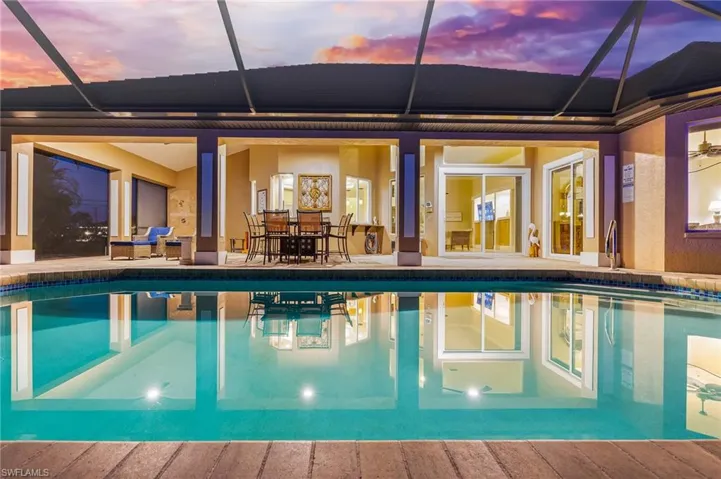 Outdoor pool featuring a patio area, outdoor dining area, a lanai, and a sunroom
