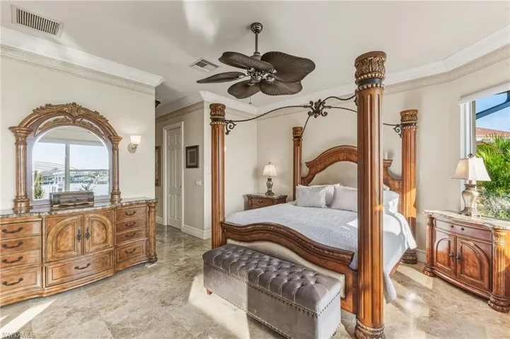 Bedroom featuring multiple windows, ceiling fan, and crown molding
