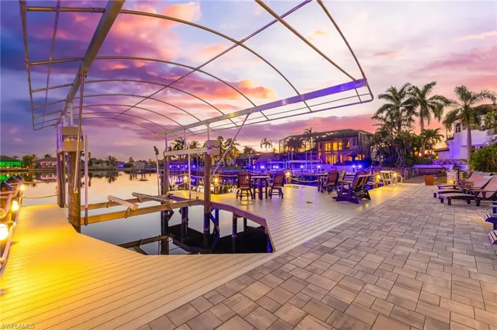 Dock area with boat lift and a water view