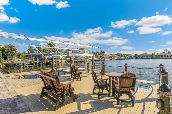 Dock area with a water view, a residential view, and boat lift