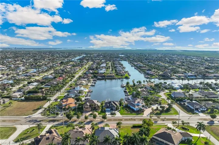 Aerial overview of property's location featuring nearby suburban area and a nearby body of water