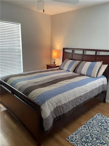 Bedroom featuring a textured ceiling and wood finished floors