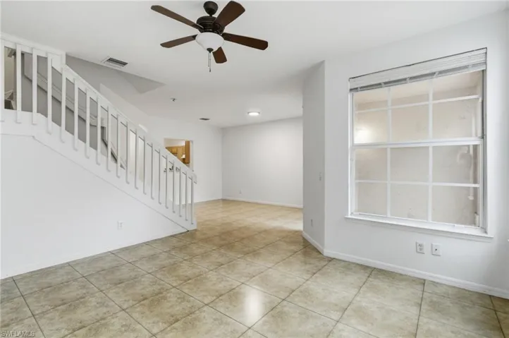 Unfurnished room featuring ceiling fan and light tile patterned floors