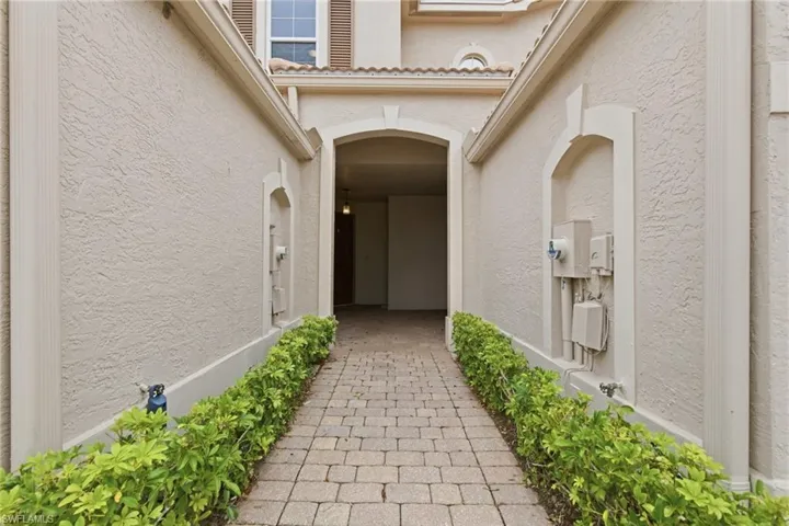 View of exterior entry with stucco siding