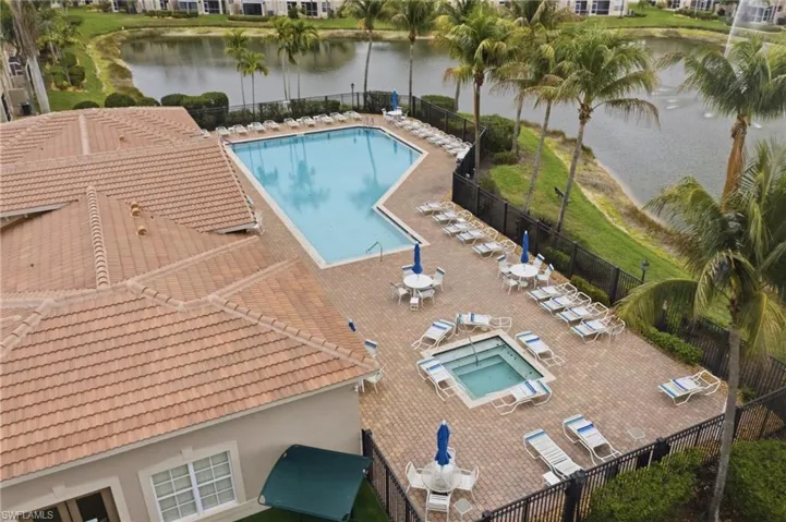 Community pool with a patio and a water view
