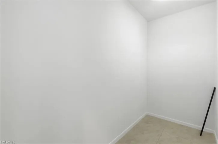 Empty room featuring baseboards