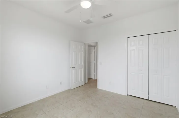 Unfurnished bedroom featuring ceiling fan and a closet