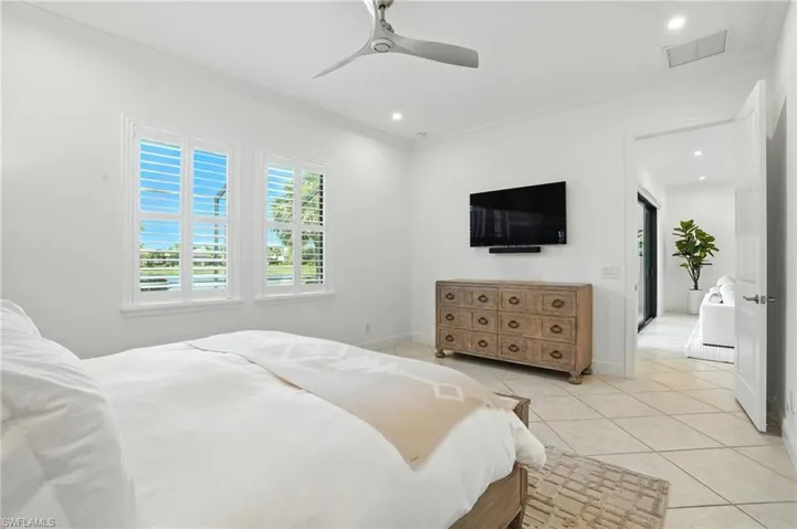 Bedroom featuring ornamental molding, light tile patterned flooring, recessed lighting, and a ceiling fan