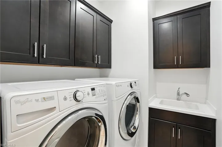 Laundry area featuring cabinet space and independent washer and dryer