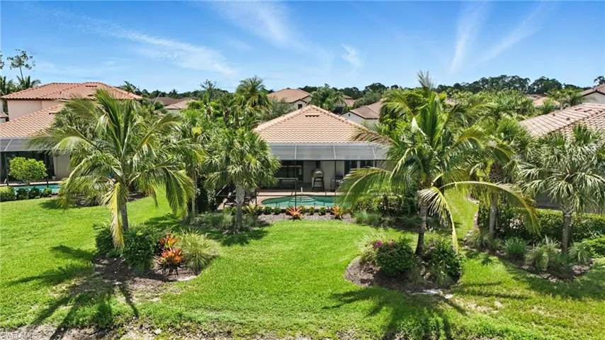 View of green lawn featuring a lanai and an outdoor pool