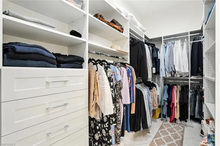Spacious closet featuring light tile patterned flooring