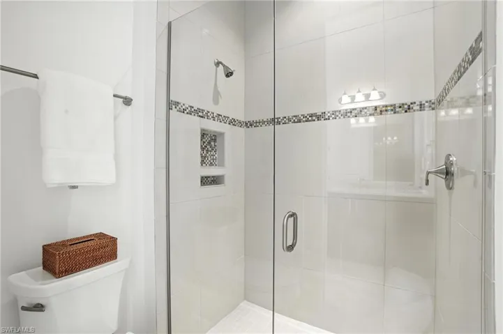 Bathroom with toilet and a stall shower