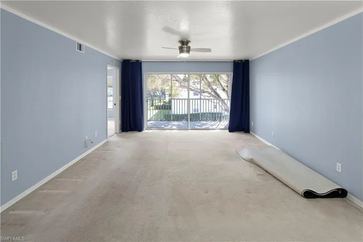Spare room featuring a ceiling fan, carpet floors, and a textured ceiling