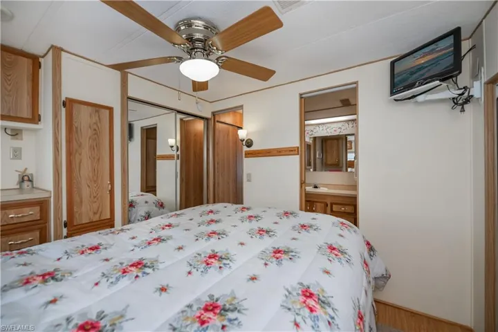 Bedroom with a sink, a ceiling fan, and ensuite bath