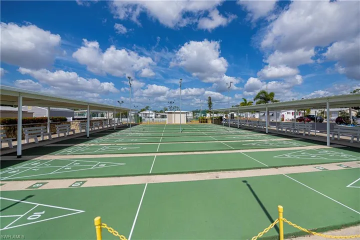 View of property's community featuring shuffleboard
