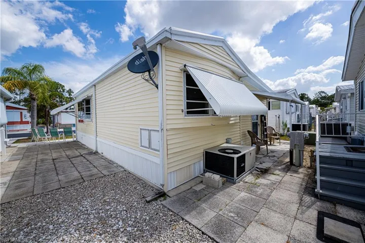 View of side of home featuring a patio area