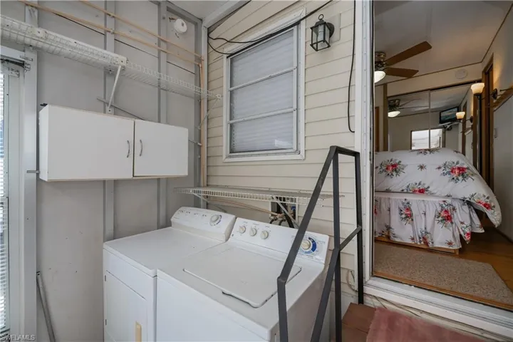 Laundry area with cabinet space, ceiling fan, and washer and clothes dryer