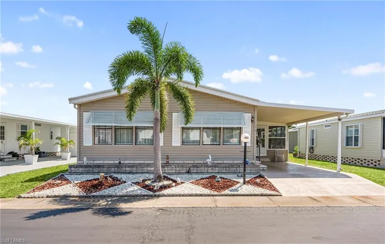 Manufactured / mobile home featuring an attached carport and concrete driveway