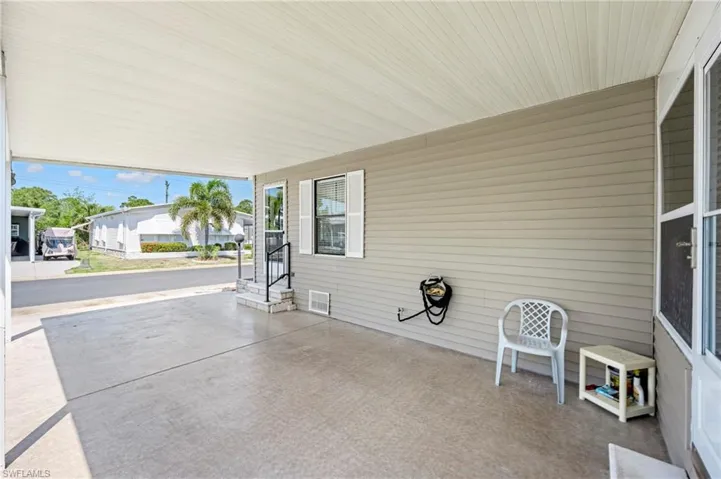 View of patio with entry steps and a carport