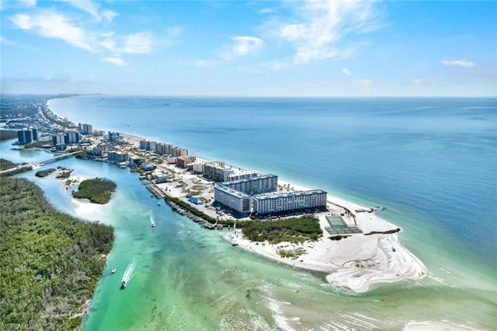 Birds eye view of property with a water view and a view of the beach