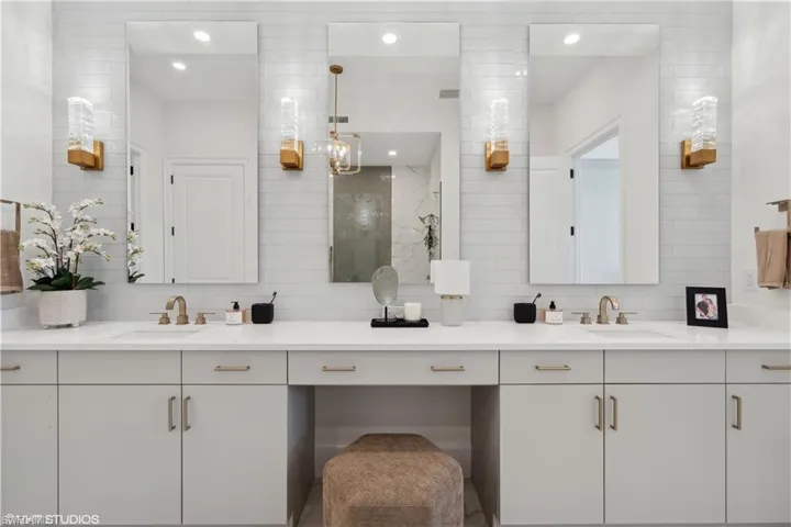 Bathroom with tasteful backsplash, vanity, and walk in shower