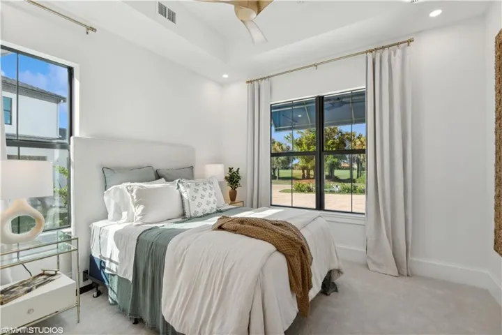Carpeted bedroom featuring ceiling fan