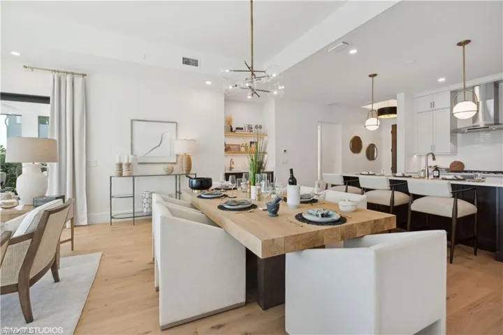 Dining area featuring light wood-type flooring and a chandelier