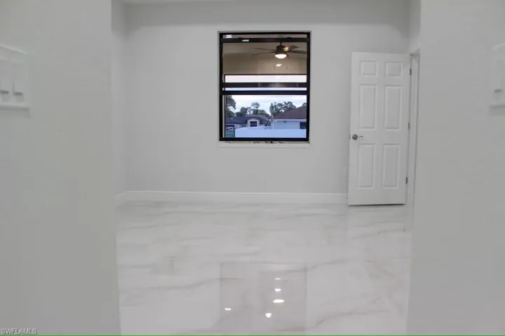 Interior details featuring a ceiling fan and baseboards