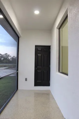 View of bathroom door connected to bedroom. Suitable for an efficiency.