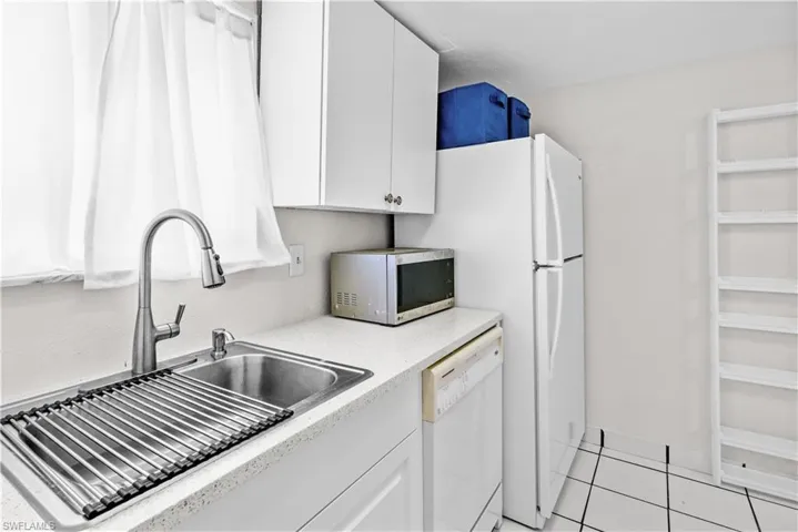 Kitchen - Window, new sink, dishwasher, microwave and refrigerator/freezer