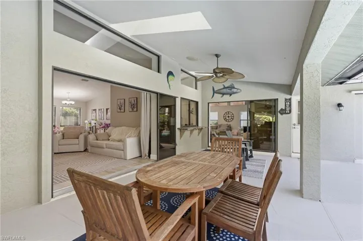 View of patio with outdoor dining area and a ceiling fan