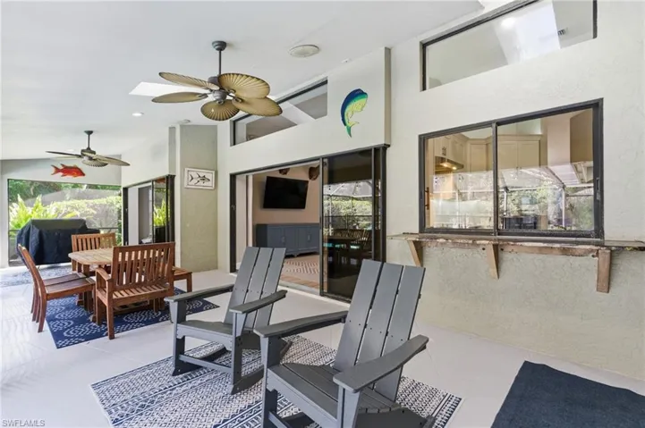 View of patio with outdoor dining area and ceiling fan