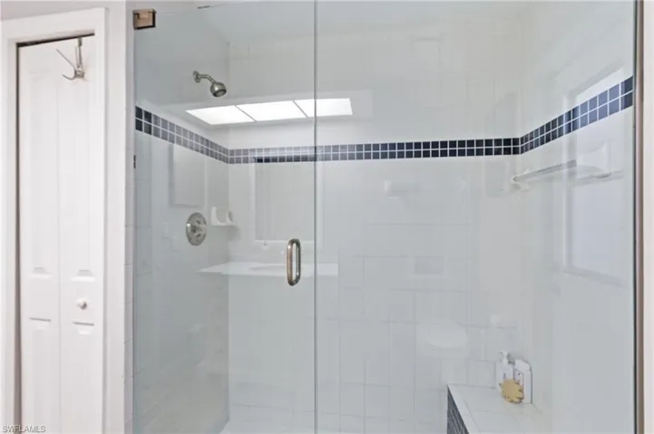 Full bathroom featuring a stall shower and a closet