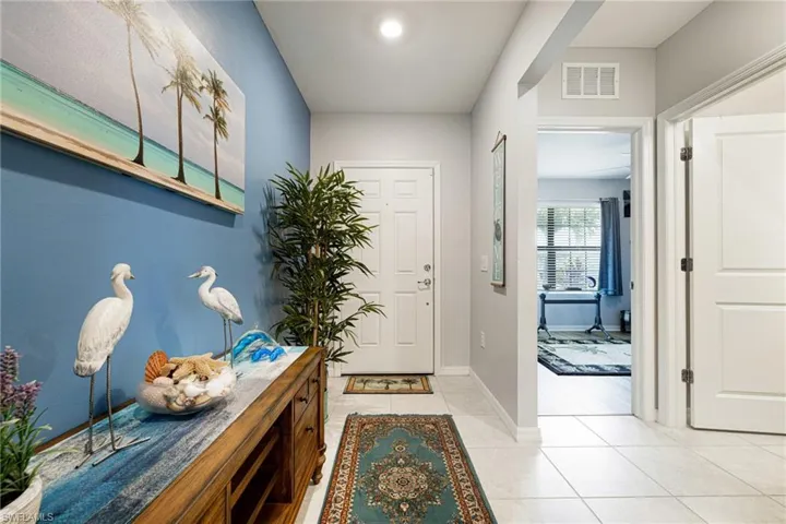 Entryway featuring baseboards and light tile patterned floors