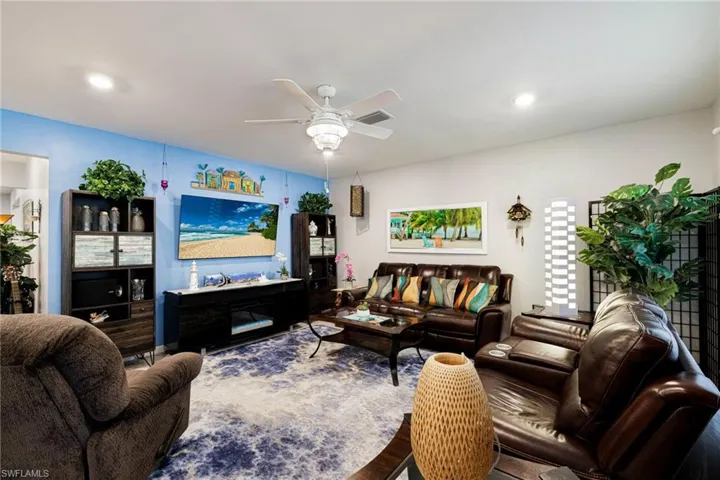 Living room featuring ceiling fan and wood finished floors