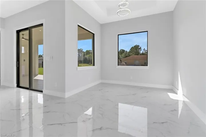 Unfurnished room with a notable chandelier