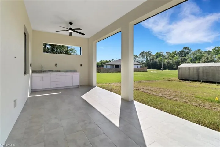 View of patio featuring ceiling fan and sink